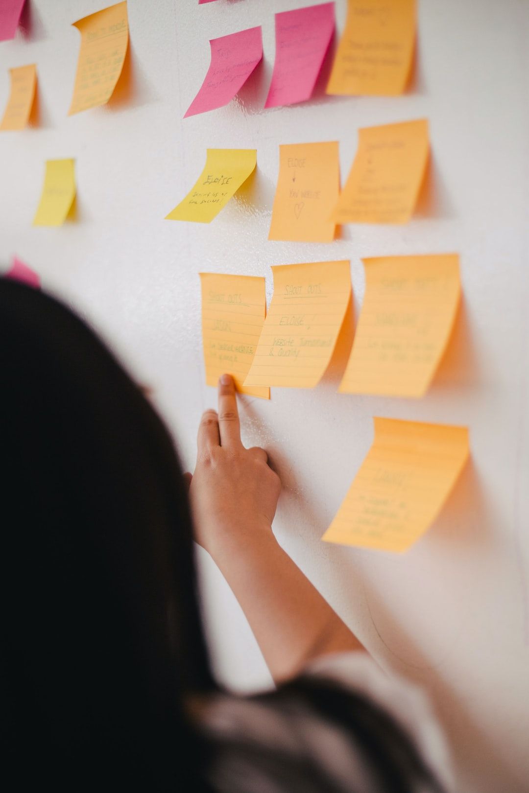 Lady putting post-its on a wall